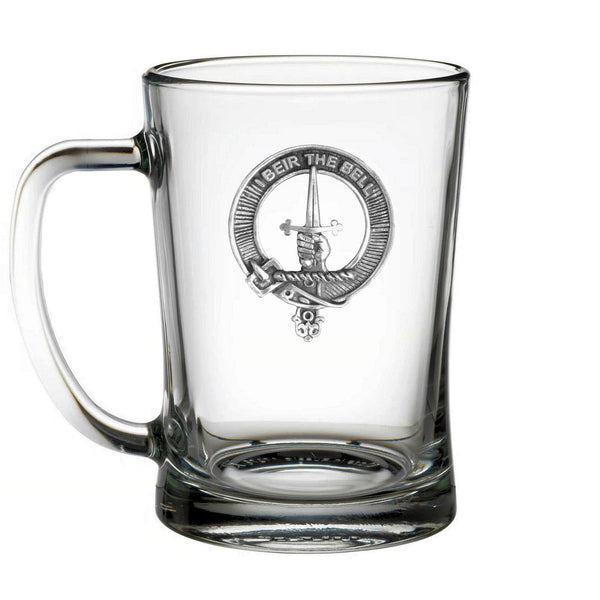 A clear glass mug with a silver emblem featuring a sword and a crown.