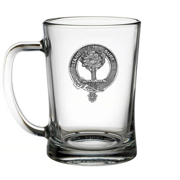 A clear glass mug with an embossed emblem on it.