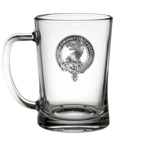 A clear glass mug with an embossed logo on it.