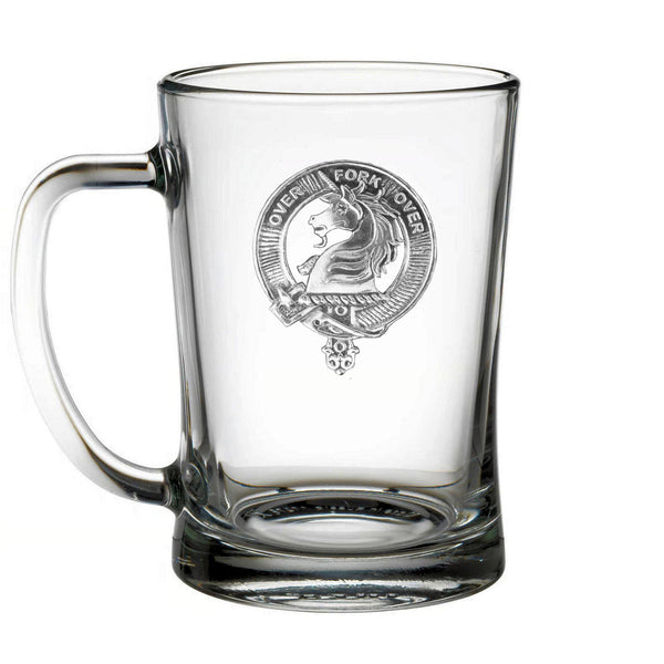 A clear glass mug with an embossed design on it.