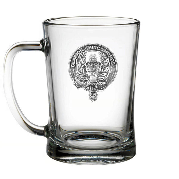 A clear glass mug with an embossed design on it.