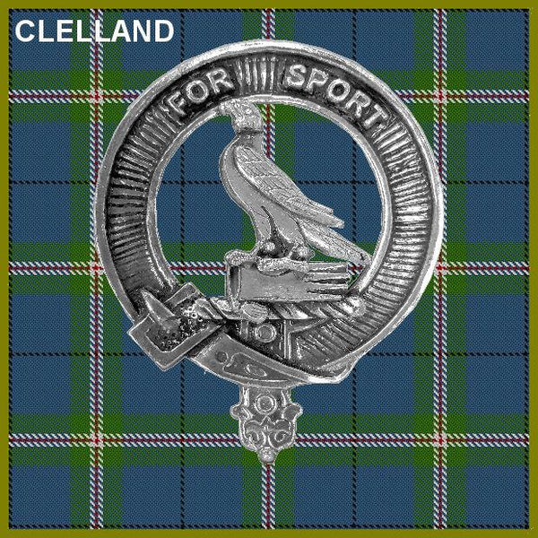 a silver metal emblem with a bird and a shield, set against a background of a plaid pattern.
