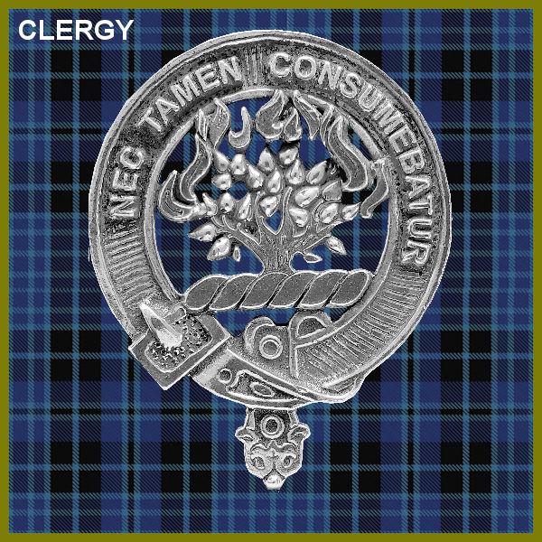 a silver-colored metal emblem with a tree design, set against a blue and black plaid background.