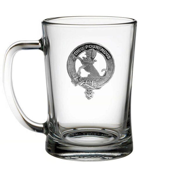 A clear glass mug with an embossed emblem on it.