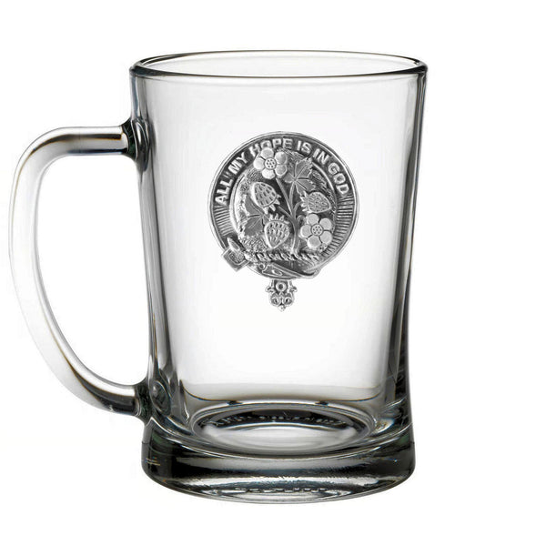 A clear glass mug with an embossed design on it.