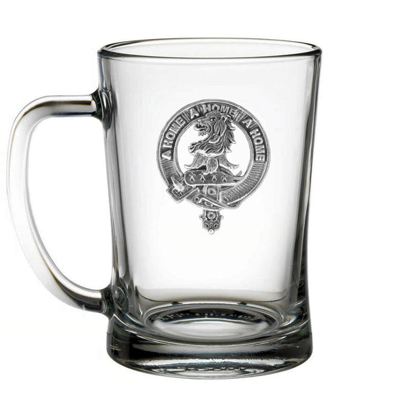 A clear glass mug with an embossed logo on it.