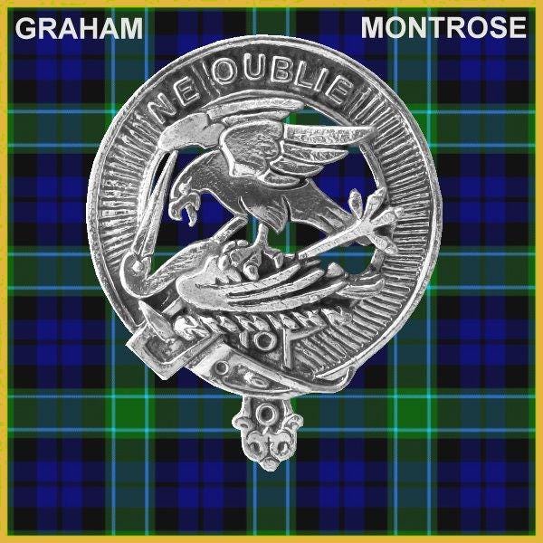 a silver badge with a bird and a shield, set against a background of a blue and green plaid pattern.