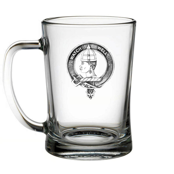A clear glass mug with a black and white design featuring a profile of a person's face and the text "WATCH MELL" around the edge.