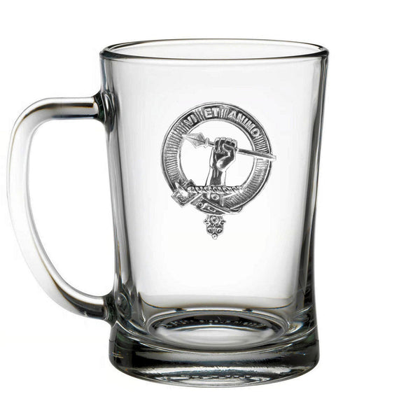 A clear glass mug with an embossed emblem on it.