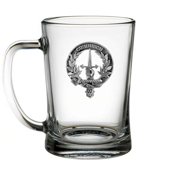 A clear glass mug with a silver emblem featuring a sword and laurel wreath.