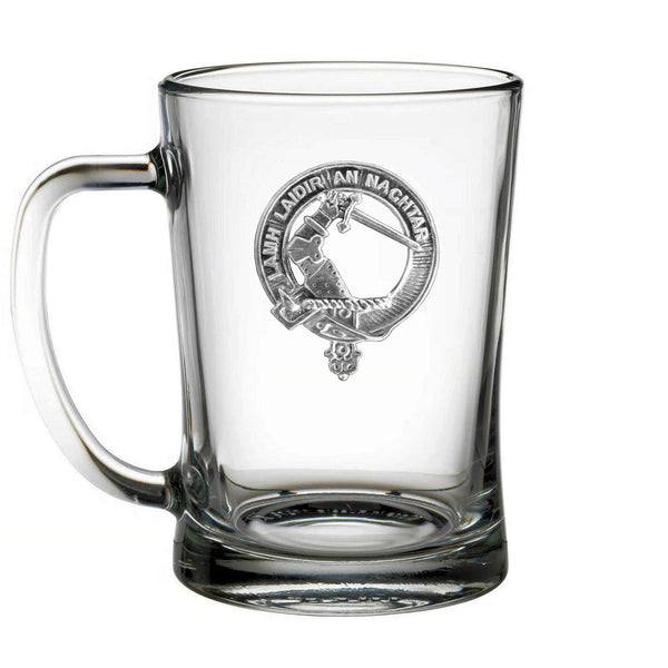 A clear glass mug with an embossed emblem on it.