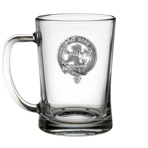 A clear glass mug with an embossed emblem on it.