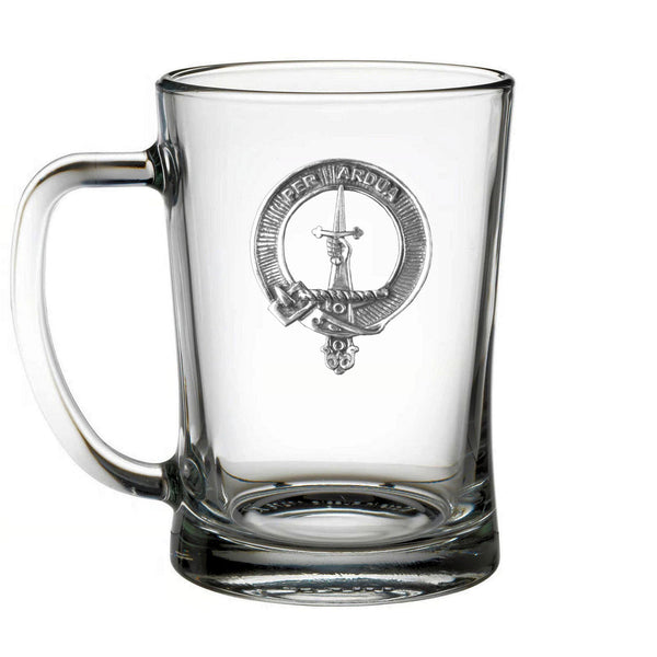 A clear glass mug with an embossed emblem on it.