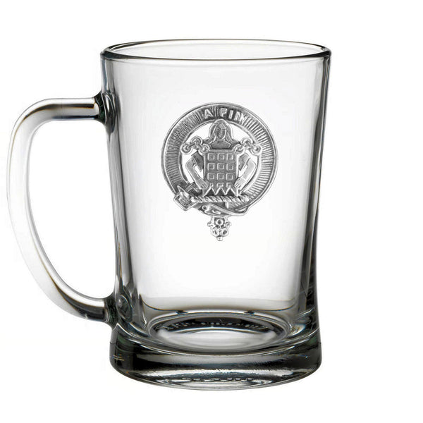 A clear glass mug with an embossed emblem on the front.