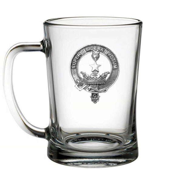 A clear glass mug with an embossed emblem on it.
