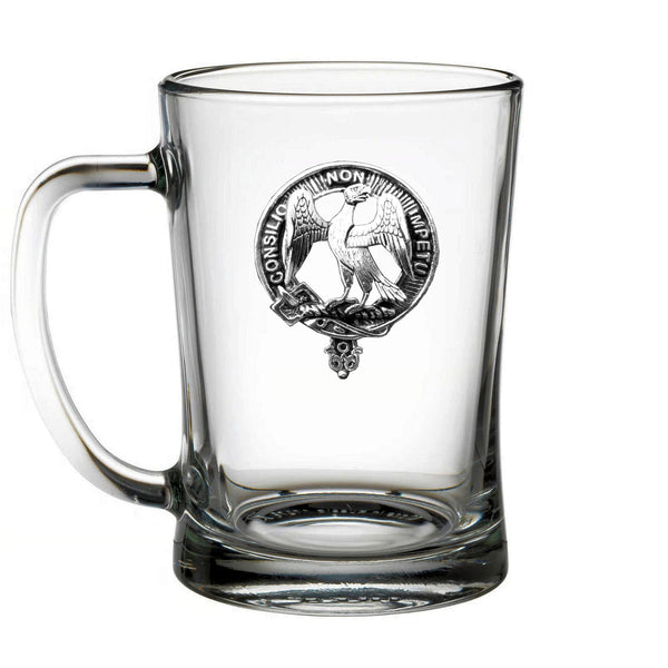 A clear glass mug with an embossed emblem featuring a bird and text.