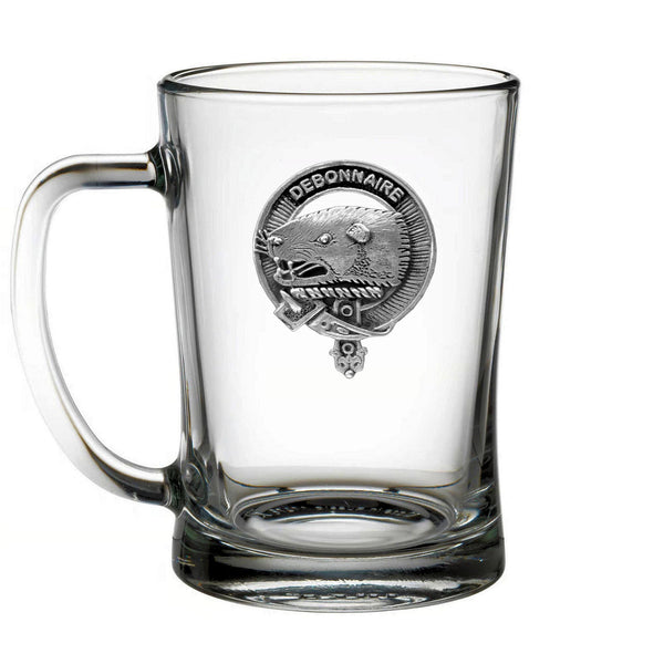A clear glass mug with a metal emblem featuring a seal and the text "DEBONNAIRE" prominently displayed.