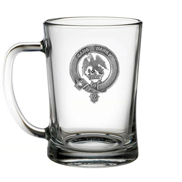 A clear glass mug with an embossed emblem on it.