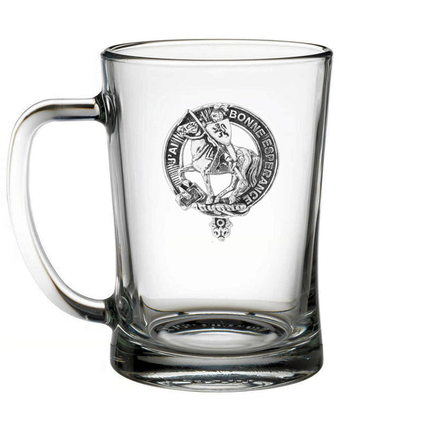 A clear glass mug with a black and white engraved design on it.