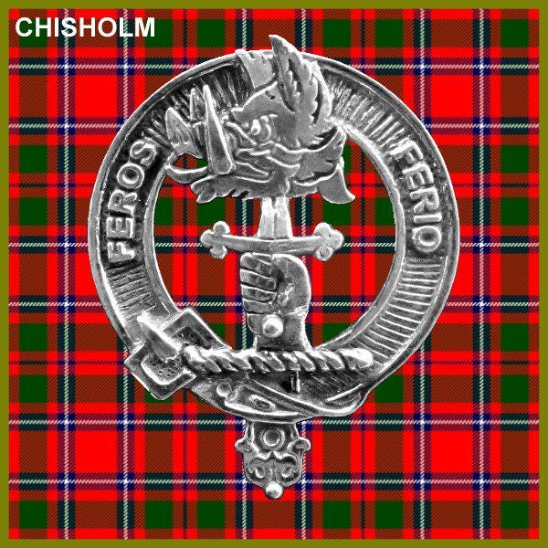 A silver metal emblem with a crest design, featuring a bird and a sword, set against a red and green plaid background.