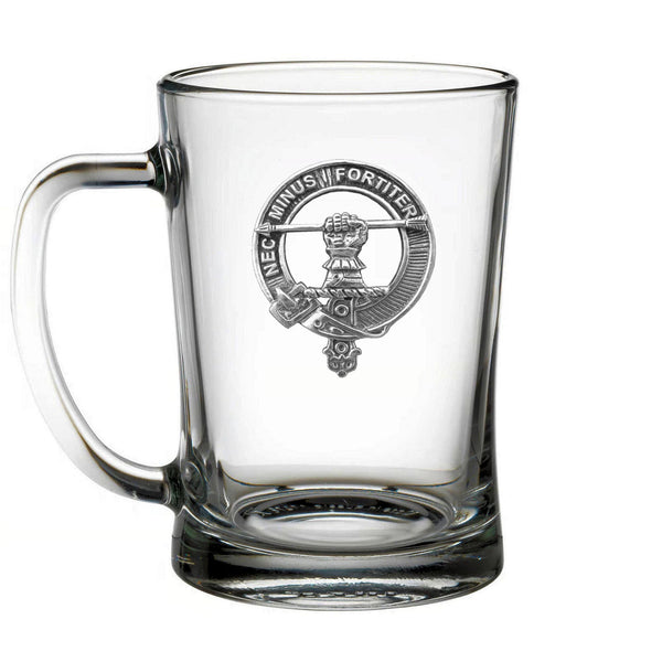 A clear glass mug with an embossed emblem on it.