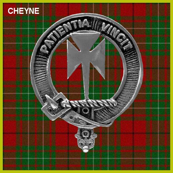 a silver badge with a cross and the text "CHEYNE" on it, set against a background of a red and green plaid pattern.