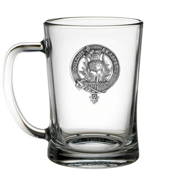 A clear glass mug with an embossed emblem on it.