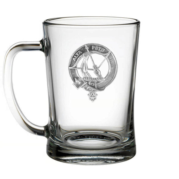 A clear glass mug with an embossed emblem on it.