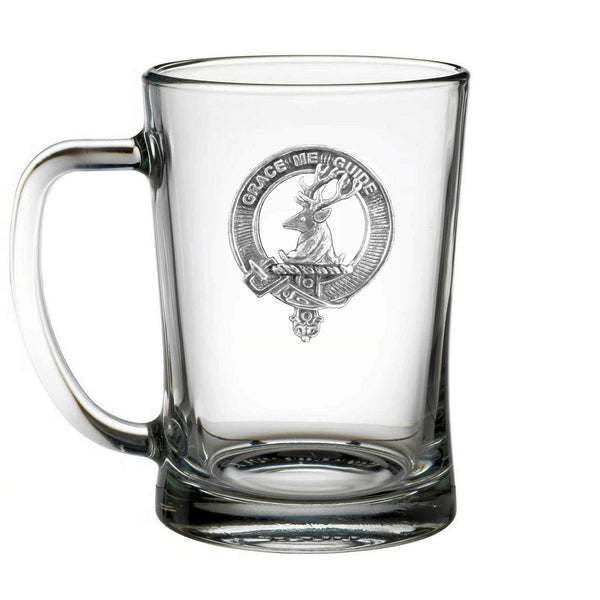 A clear glass mug with an embossed emblem featuring a deer and the words "Grace in my care" printed on it.
