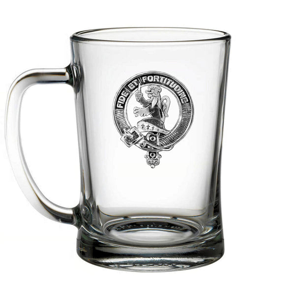 A clear glass mug with a black and white design featuring a crest or emblem.