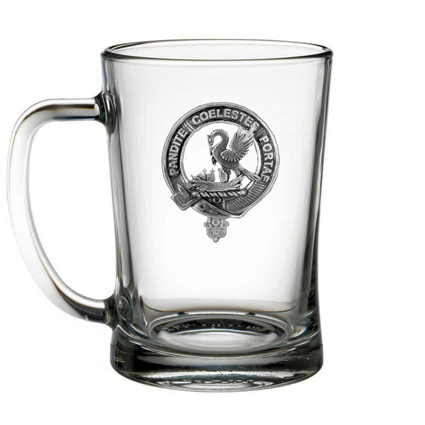 A clear glass mug with an embossed emblem on it.
