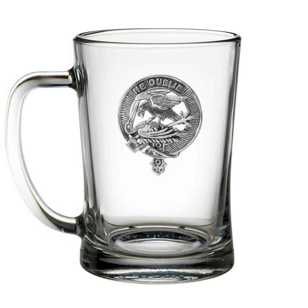 A clear glass mug with an embossed emblem on it.