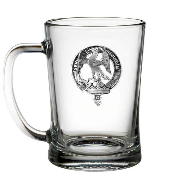 A clear glass mug with an embossed emblem featuring a bird and a crown.