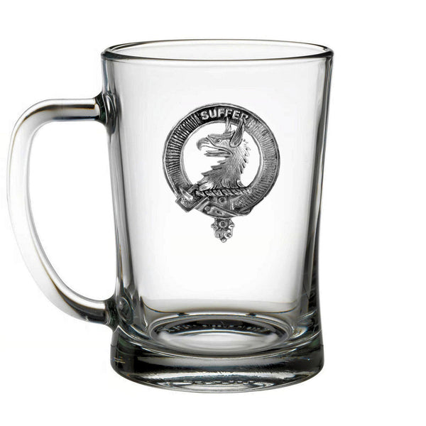 A clear glass mug with a metal emblem featuring an eagle and the word "SUPER" printed on it.
