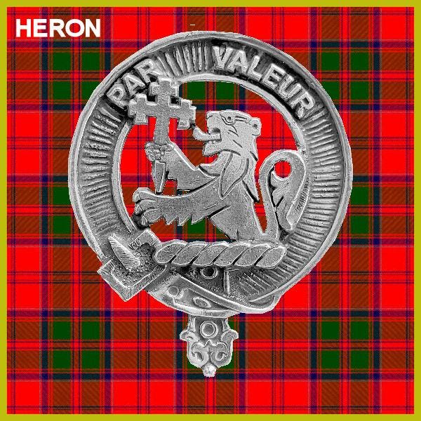a silver emblem with a lion and a cross, set against a red and green plaid background.