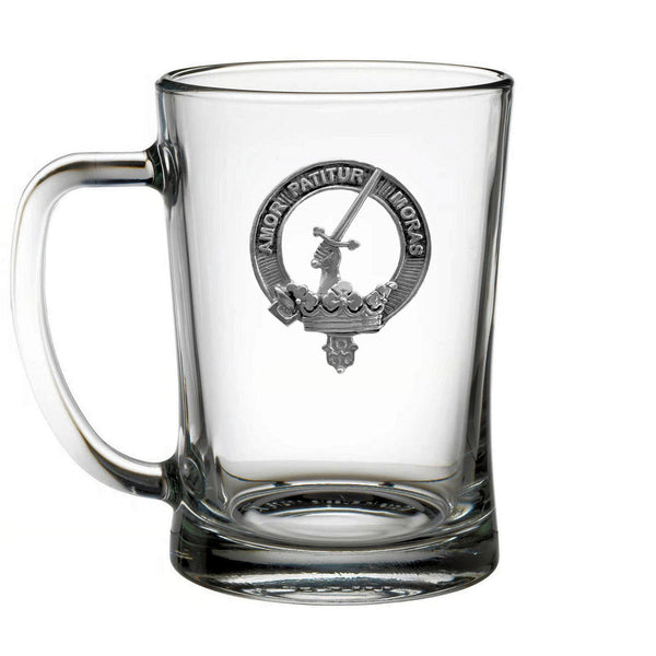 A clear glass mug with a silver emblem featuring a sword and a crown.