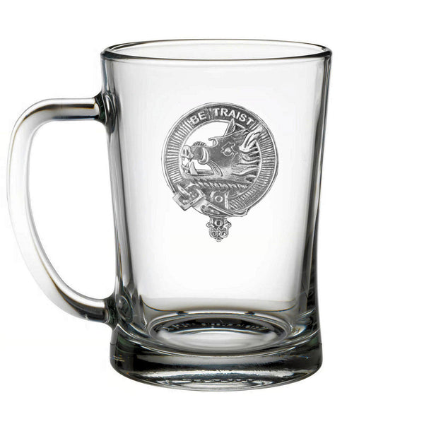 A clear glass mug with an embossed design on it.