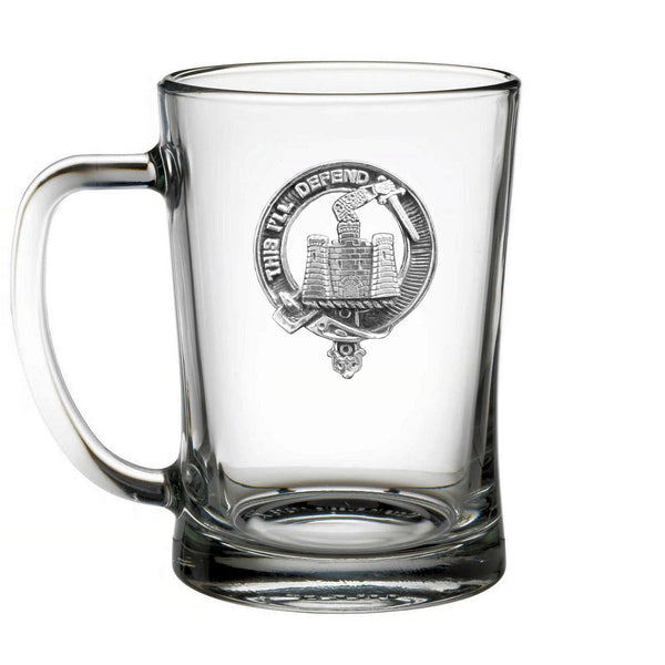 A clear glass mug with an embossed design on it.
