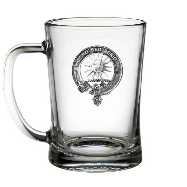 A clear glass mug with an embossed logo on it.