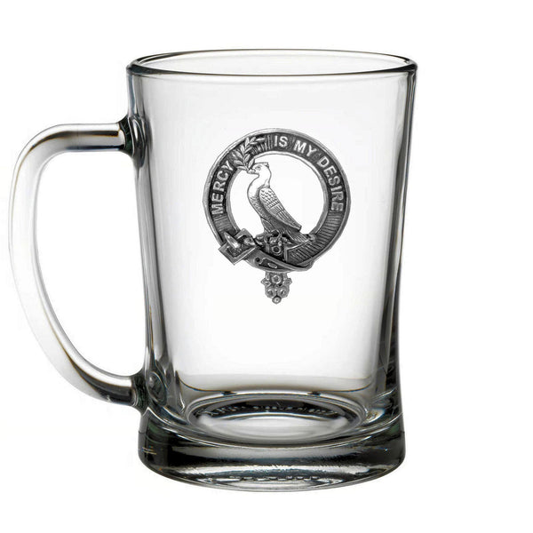 A clear glass mug with an embossed design featuring a bird and the text "MERCY IS MY DESIRE".