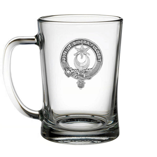 A clear glass mug with an embossed emblem on it.