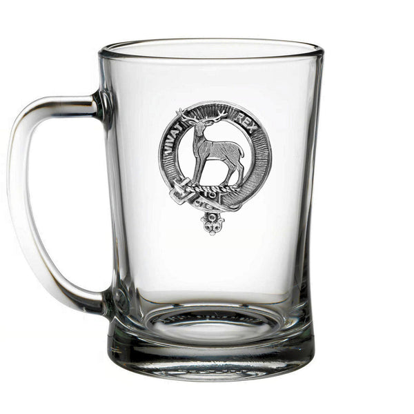A clear glass mug with a metal emblem featuring a deer and the text "REX" inside a circular design.