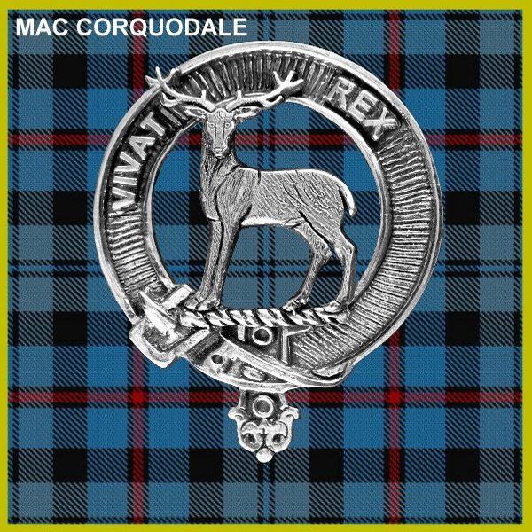 a silver badge with a deer emblem, set against a blue and red plaid background.