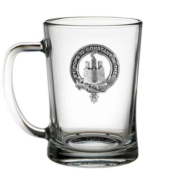 A clear glass mug with an embossed design featuring a castle or tower.