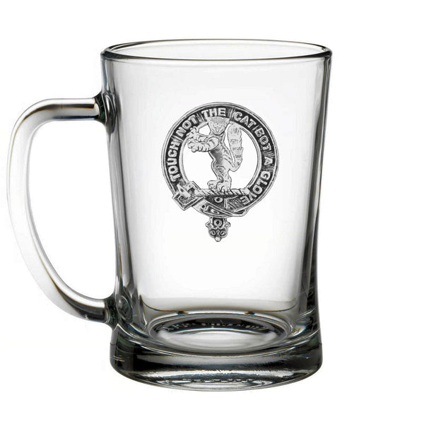 A clear glass mug with an embossed logo on it.