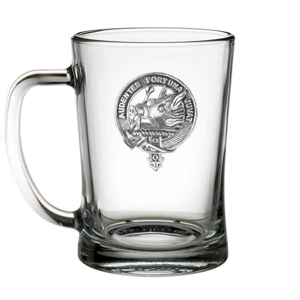 A clear glass mug with an embossed design on it.