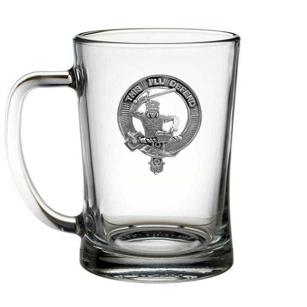 A clear glass mug with an embossed design on it.