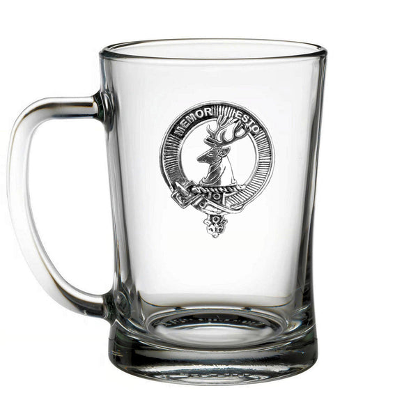 A clear glass mug with a metal emblem featuring a deer and the text "MEMORIES" inside a circular design.