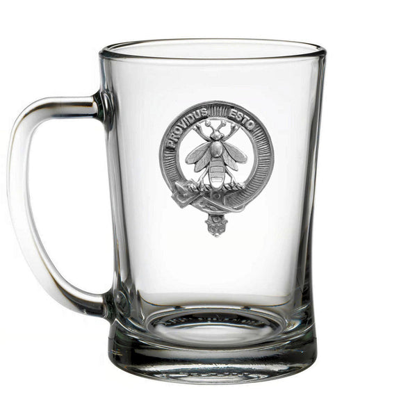 A clear glass mug with a silver emblem featuring a bee and the text "PROVIDUS ESTO" printed on it.