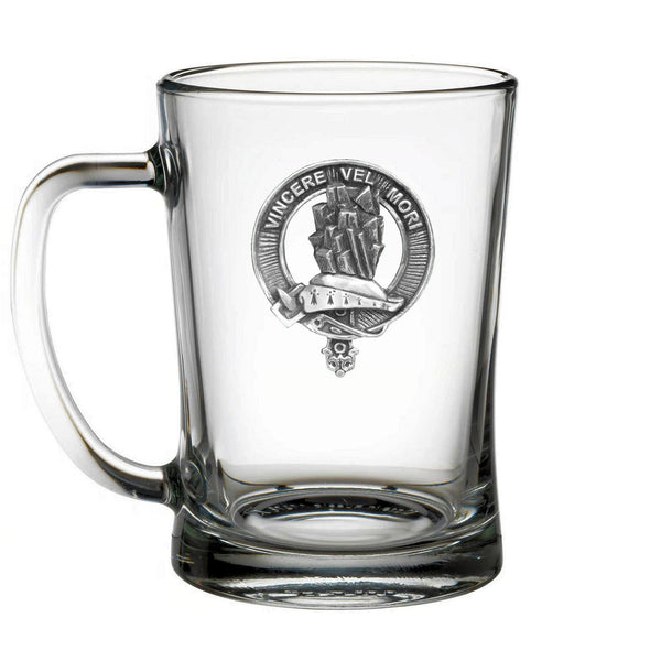 A clear glass mug with an embossed logo on it.